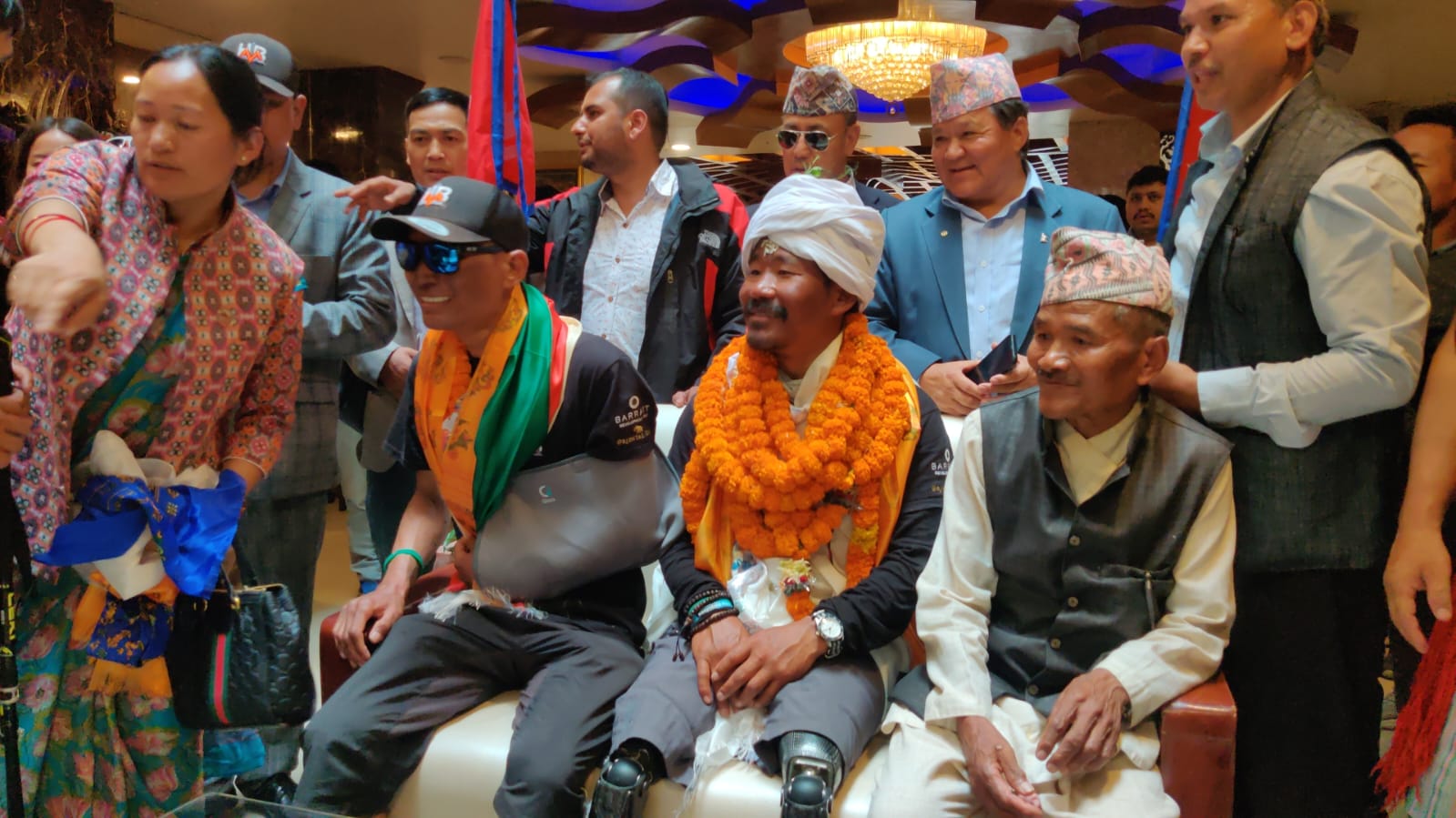 Gurkha veteran Hari Budha Magar with his father and brother at the Kathmandu hero's welcome CREDIT Kiran Acharya
