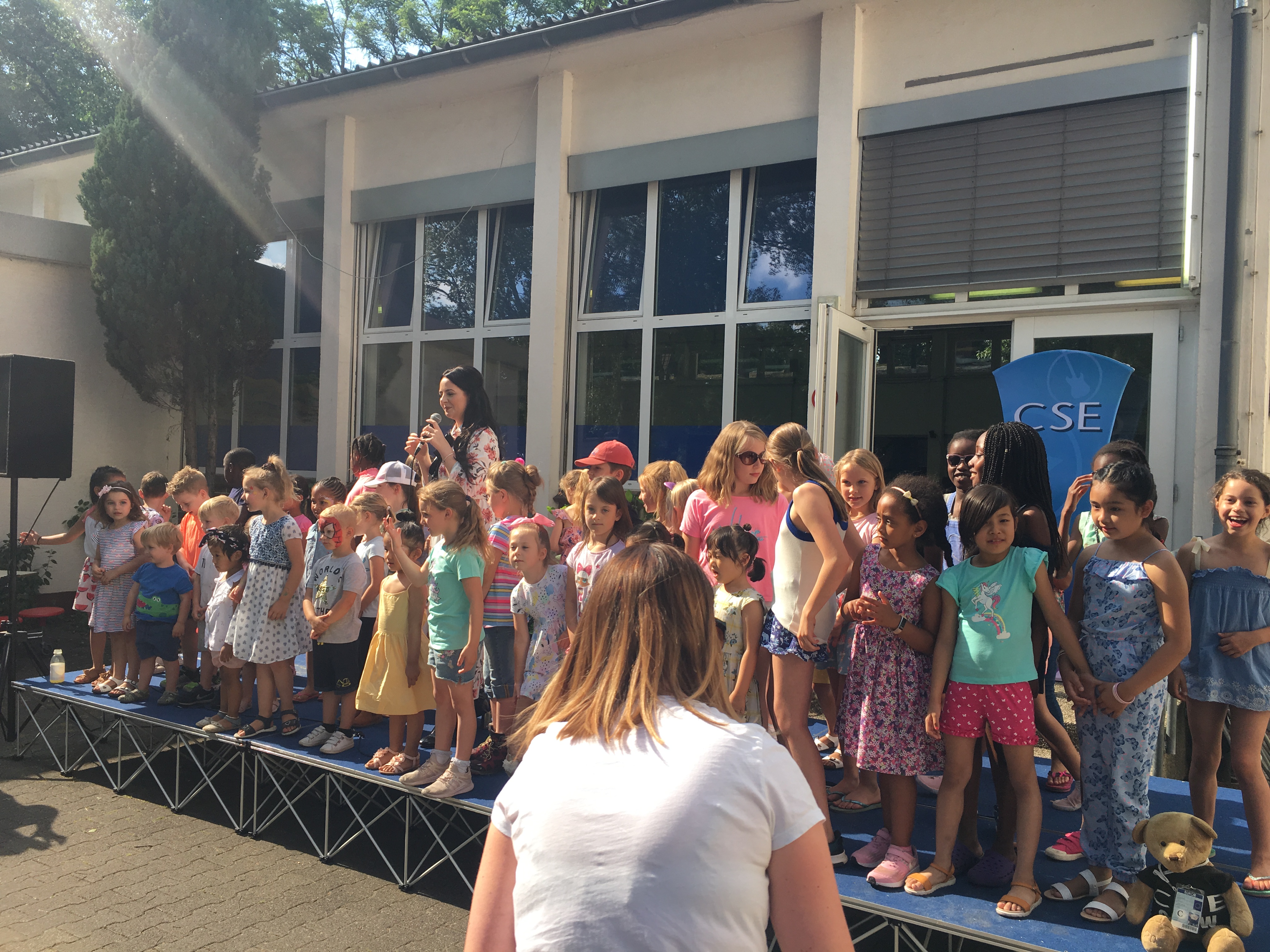 Shellyann Evans on stage with children from Attenborough School, Germany