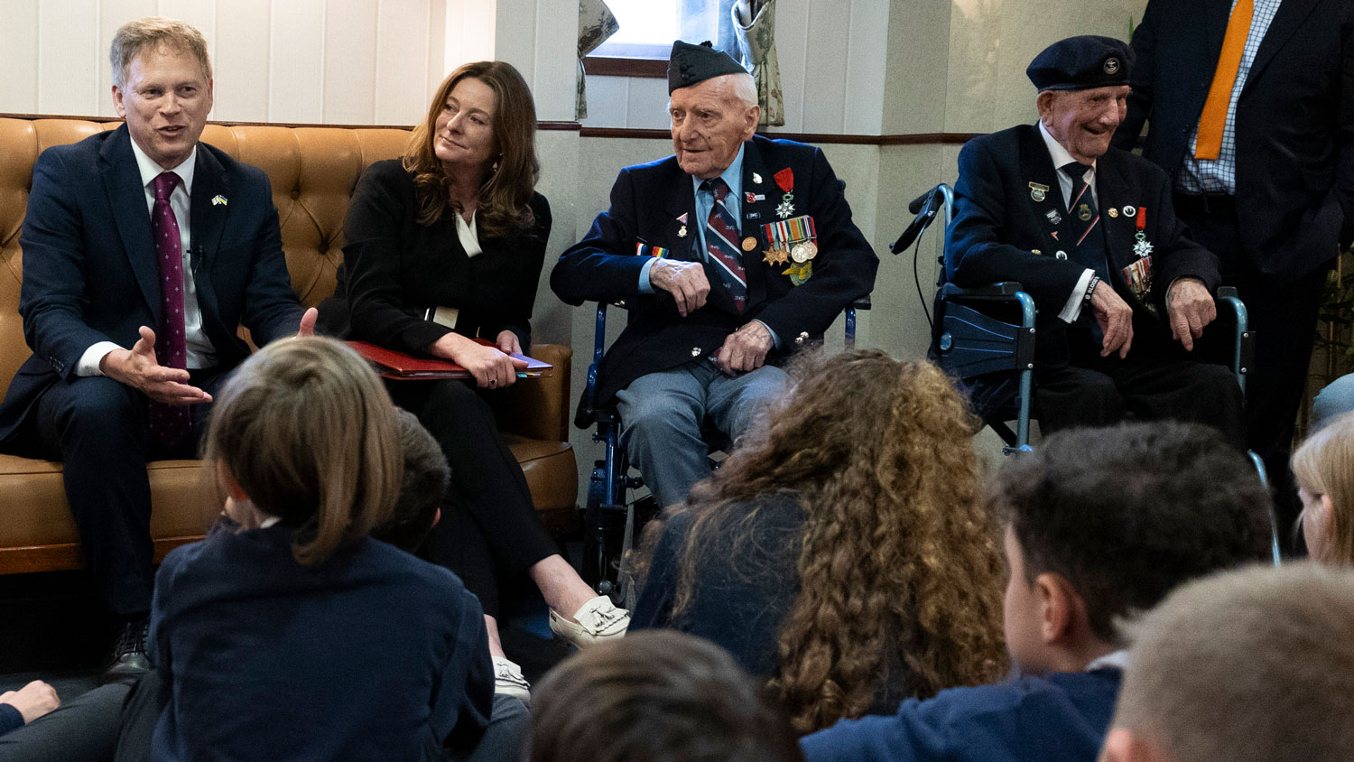 Left to right, Defence Secretary Grant Shapps, Education Secretary Gillian Keegan and D-Day Veterans Bernard Morgan and George Chandler take questions from school children onboard HMS Belfast on 21 May 2024 CREDIT Crown Copyright