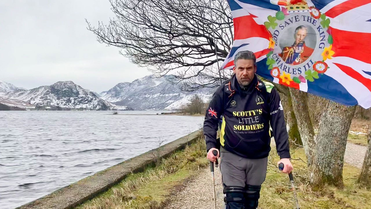 Mark Harding with King's flag CREDIT Scotty's Little Soldiers
