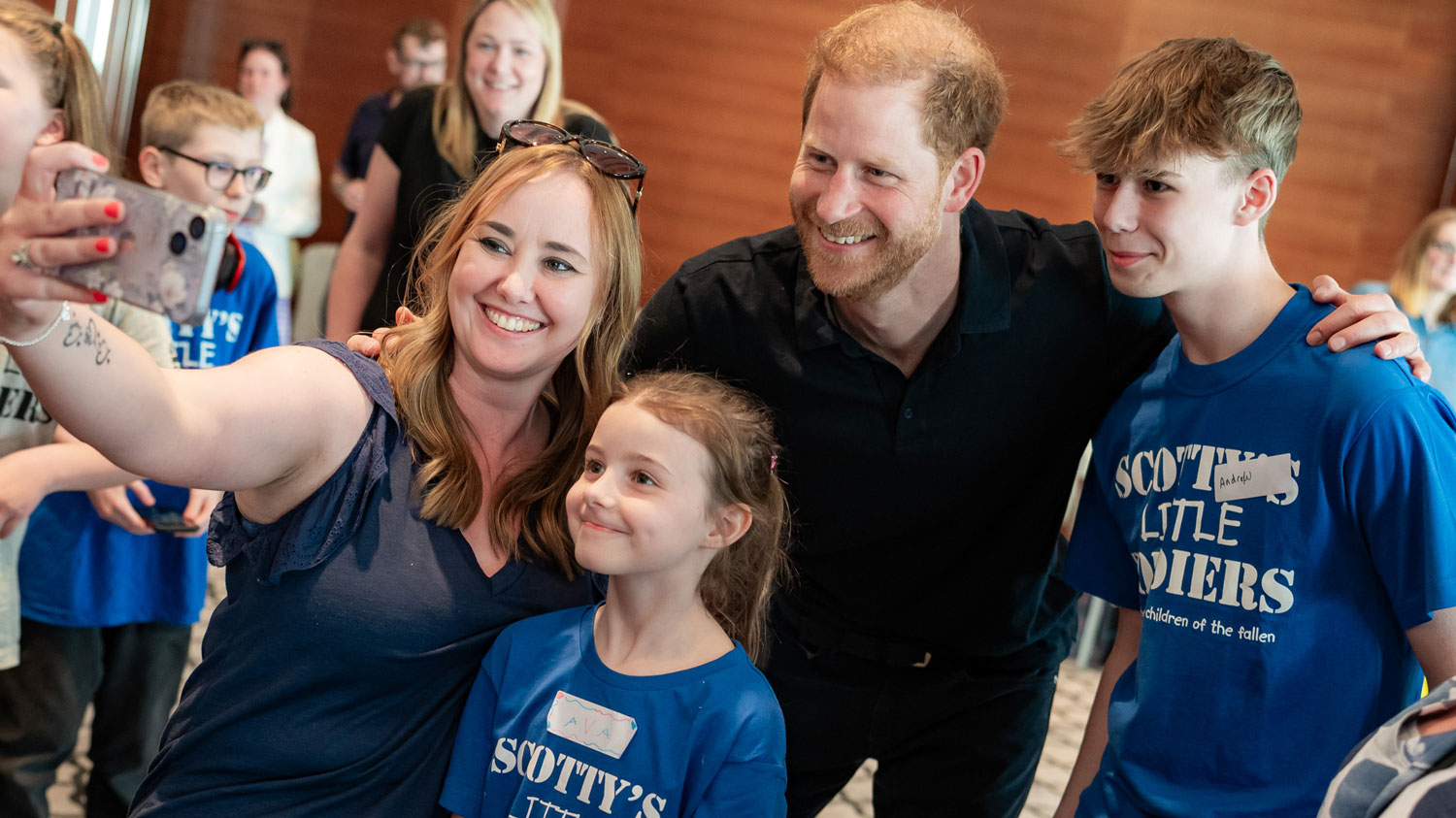 Prince Harry poses for a photo with the youngsters (Picture: Scotty’s Little Soldiers)