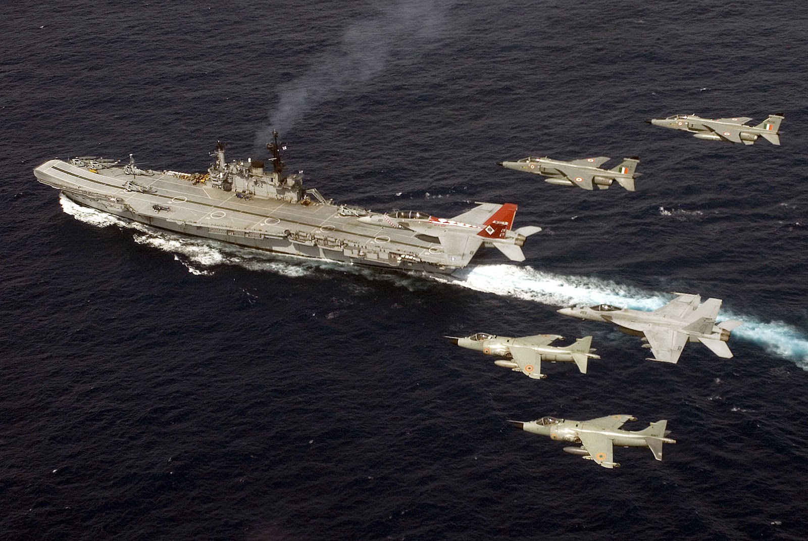 Indian Air Force Jaguars, Indian Navy Sea Harriers, and U.S. Navy F/A-18 Super Hornets, flying in formation over INS Viraat during Exercise Malabar