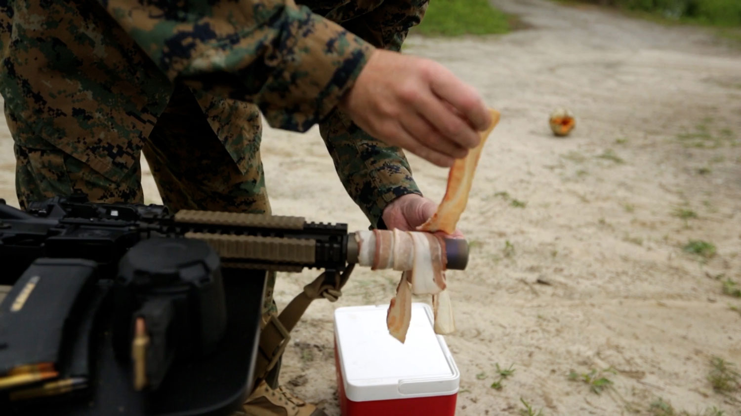 Retired US Marine Corps Chief Warrant Officer 5 Christian Wade attempts to cook bacon using the heat of his gun's suppressor 2 CREDIT US Department of Defense