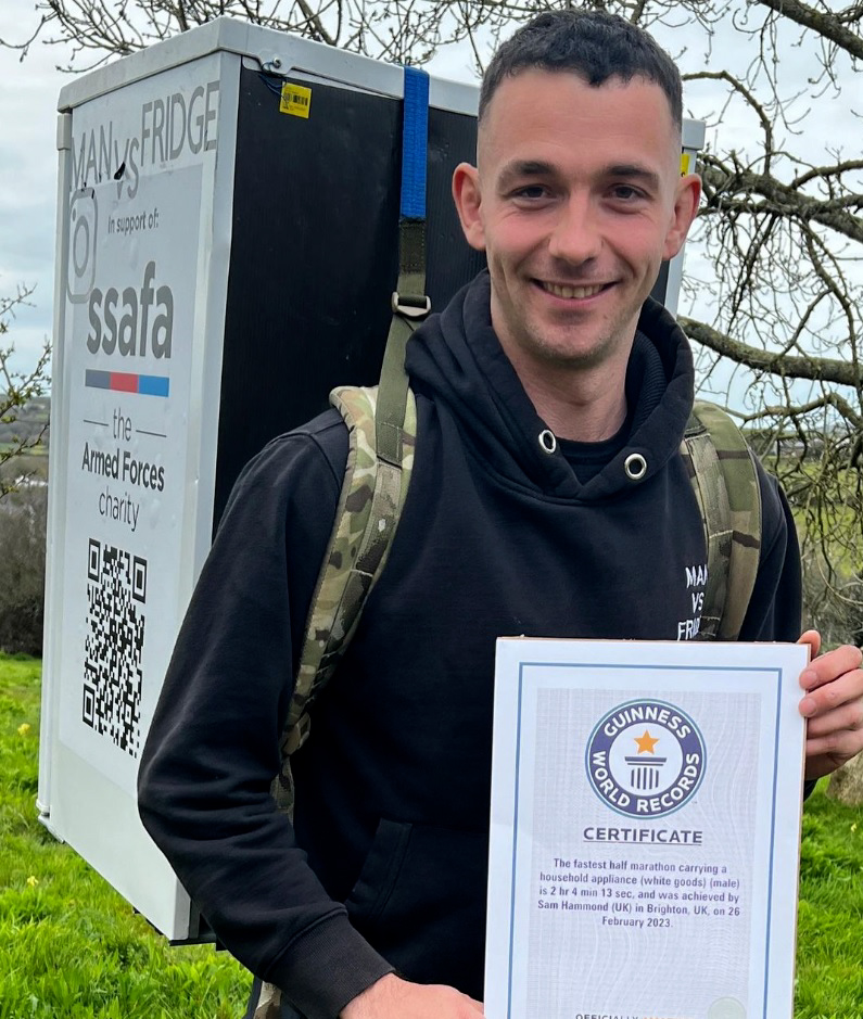 Corporal Sam Hammond has been officially recognised by the Guinness Book of Records for the fastest half marathon time whilst carrying a household appliance (Picture: Sam Hammond).