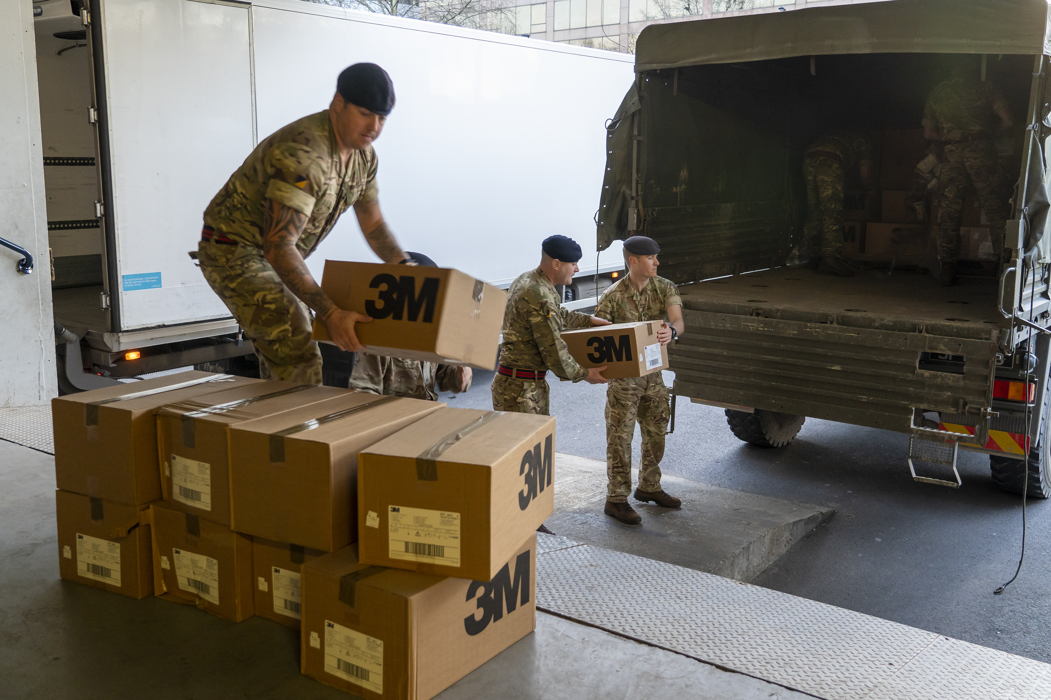 Soldiers unloading medical supplies at London hospital.
