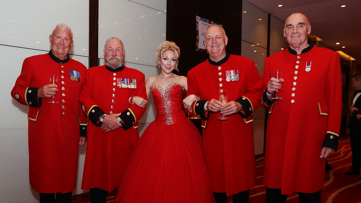Soprano Christina Johnston poses with Chelsea Pensioners at the 2023 Soldiering On Awards CREDIT Schmooly