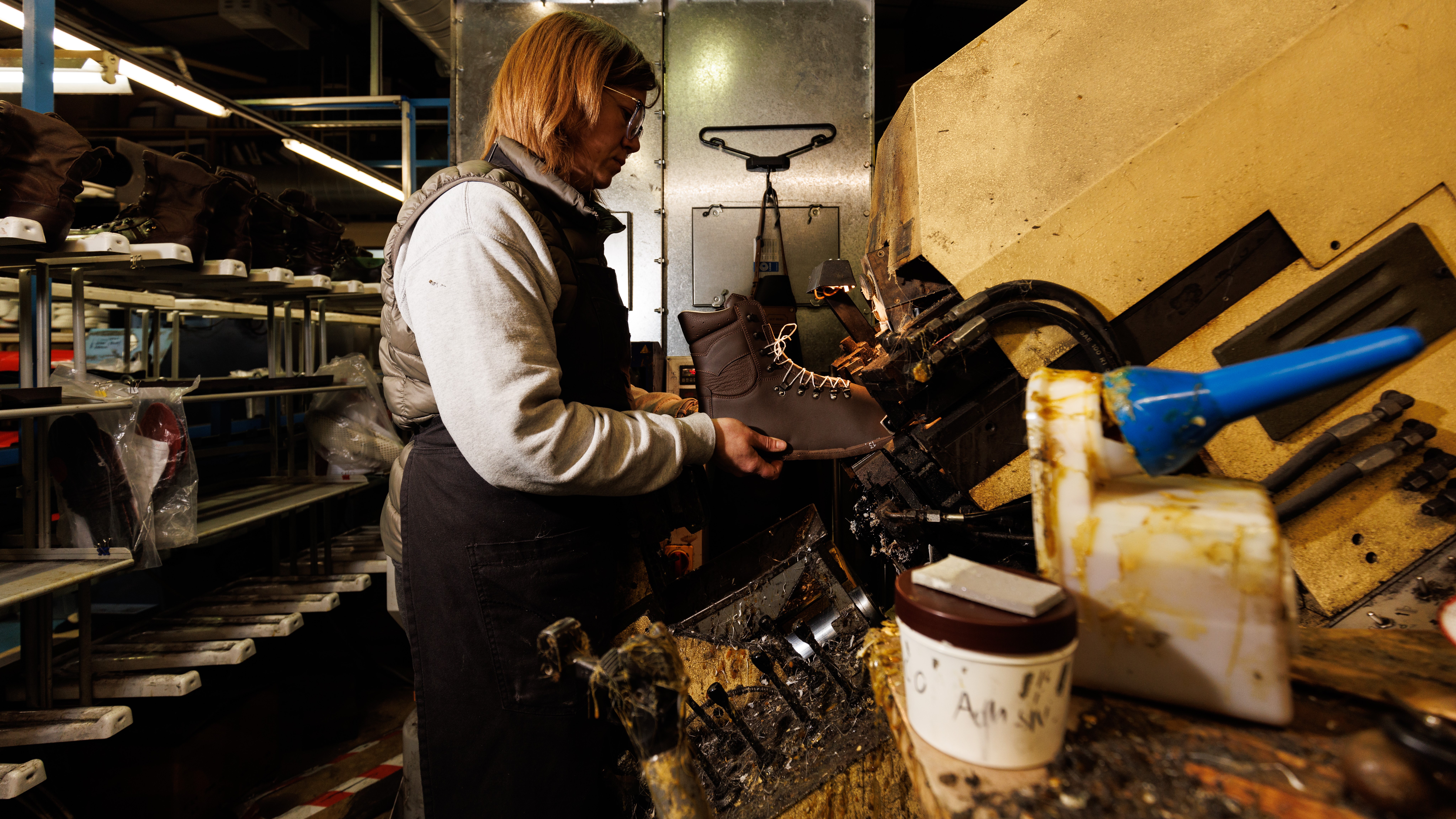 staff holds a boot in place while using one of many machines in the Altberg factory 28112022 CREDIT MOD Crown Copyright