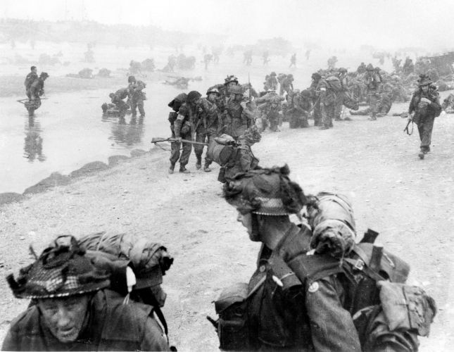 British soldiers struggle ashore on Sword beach 