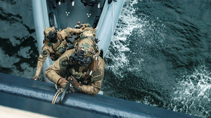Operating with boarding ladders to make entry onto a target Operating with boarding ladders to make entry onto a target