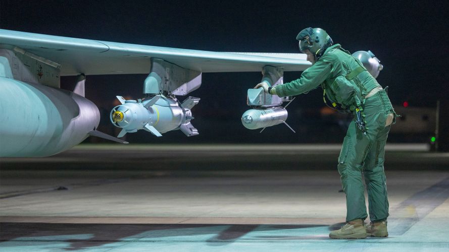 A pilot examines the weapons hardpoints of his RAF Typhoon FGR4 during his pre-flight checks before carrying out an attack on an Islamic State underground facility near Palmyra in Syria