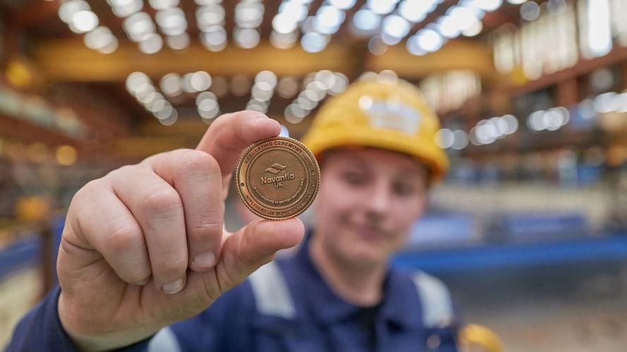 A Navantia UK apprentice with the coin which was welded to the keel (Picture: Royal Navy) A Navantia UK apprentice with the coin which was welded to the keel (Picture: Royal Navy)