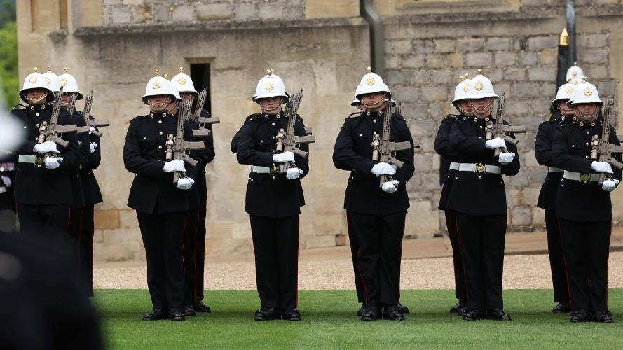 Royal Marines slope arms with their assault rifles - the Corps operates the  Knight's Armament KS-1 alongside the SIG Sauer MCX (Picture: MOD)