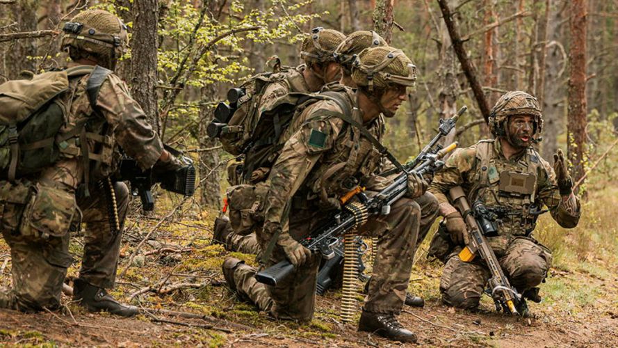 A designated marksman from A Company, 3 Para, briefs his section as they prepare to assault a US enemy position during Exercise Fly Trap in Lithuania