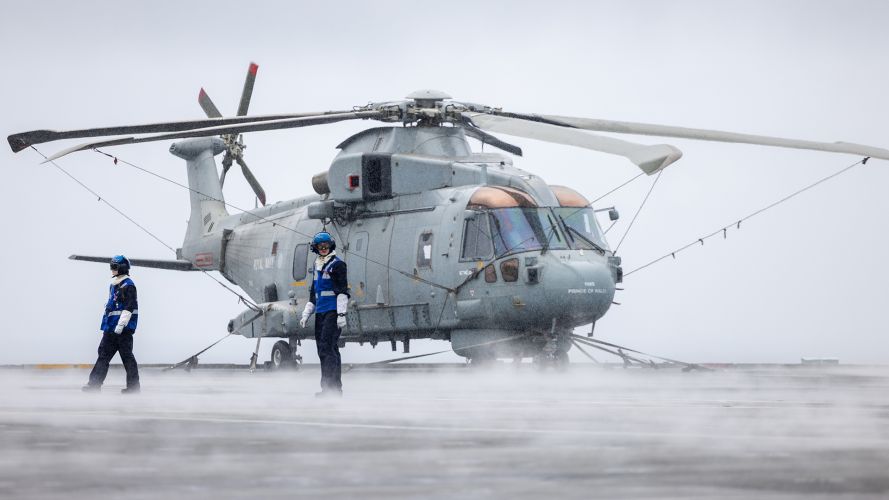 Aircraft handlers secure a Merlin Mk2 on the flight deck of HMS Prince of Wales - the Mk2 is principally an anti-submarine warfare helicopter, although it can carry out other roles, such as search and rescue and maritime patrol