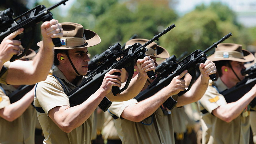 Members of the Royal Australian Corps of Signals conduct a Feu de joie during the Royal Australian Corps of Signals centenary parade at Victoria Barracks in Sydney