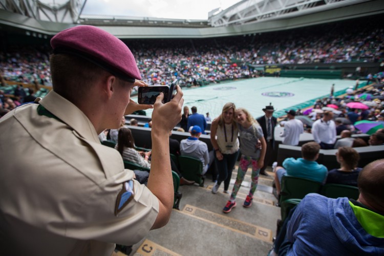 Private O'Brien takes a picture for spectators on Centre Court