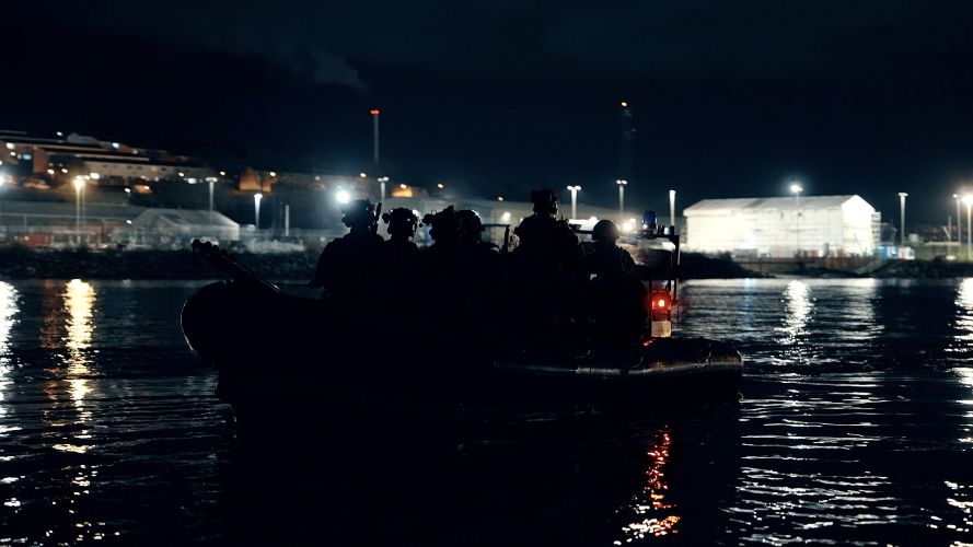 In the dead of night, Royal Marines from 42 Commando embark towards the auxiliary ship SD Northern River in Devonport Naval Base