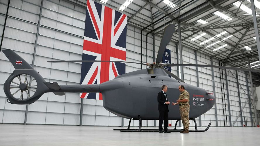 Defence Secretary and former para Dan Jarvis stands in front of the Proteus full-scale autonomous helicopter which is being developed for the Royal Navy at the Panattoni site in Swindon