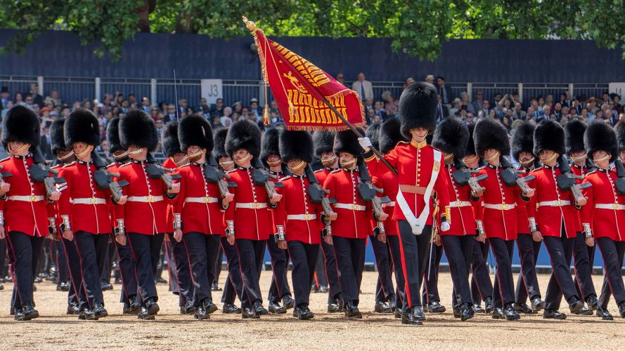 As the Guardsmen do an eyes right as they pass the podium from which the monarch is returning their salute, the Colour is flourished in front of the King