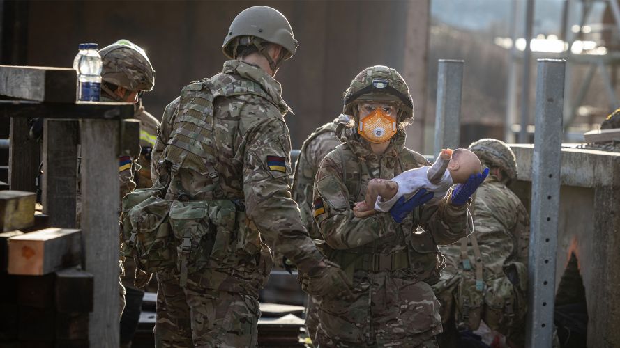 Private Cooke rushes a simulated baby to get urgent treatment as reservists from Glasgow-based 144 (Parachute) Medical Squadron test their specialist medical skills alongside their civilian colleagues
