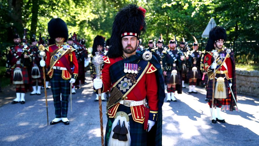 The pipe band of 3 & 4 SCOTS, Royal Regiment of Scotland march through the gates of Balmoral 