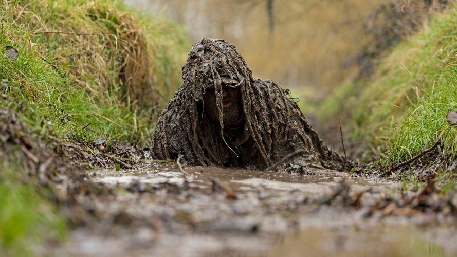 A soldier crawls through a ditch of muddy water as part of the Sniper Operators Course (SOC) at the Combined Arms Manoeuvre School in Warminster (Picture: MOD) 19082026 A member of the British Army is seen here crawling through a ditch of muddy water as part of the Sniper Operators Course (SOC) at the Combined Arms Manoeuvre School in Warminster pic MOD