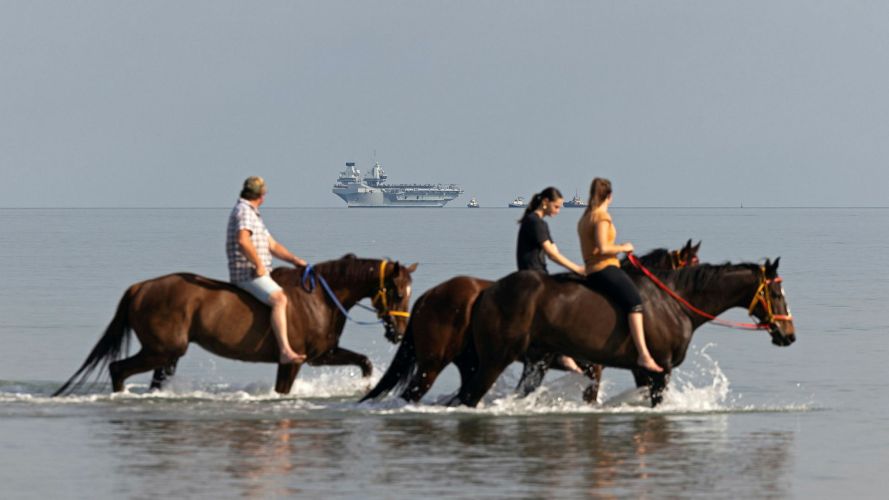 Darwin residents go horseback riding in the shallows as HMS Prince of Wales approaches Darwin Harbour in Australia, during the UK Carrier Strike Group deployment, Operation Highmast (Picture: MOD) 19082026 Darwin residents go horseback riding in the shallows as HMS Prince of Wales approaches Darwin Harbour in Australia, during the UK Carrier Strike Group deployment, Operation Highmast pic MOD