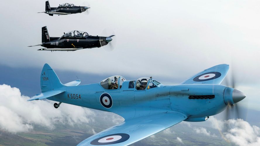 An iconic Spitfire TR9 'K5054' flying alongside a Texan from MOD St Athan in the UK as part of the Spitfire90 tour (Picture: MOD) 19082026 iconic Spitfire TR9 “K5054”, flying alongside a Texan from MOD St Athan in the UK as part of the Spitfire90 tour Pic MOD