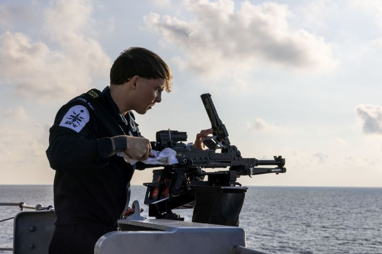 HMS Richmond's crew pictured cleaning their weapons during the rare transit