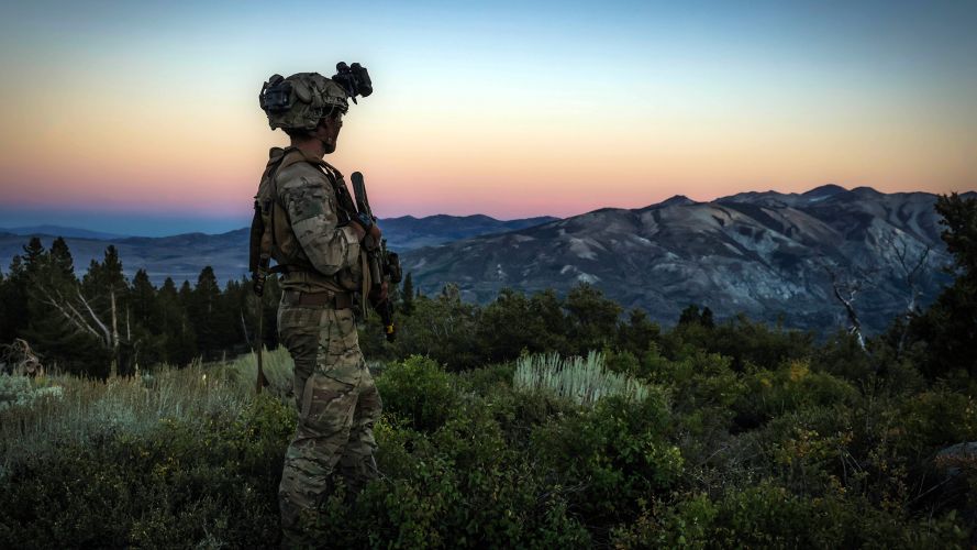 A commando from Air Defence Troop, 29 Commando, surveys the ground in low light while deployed to the Mountain Warfare Training Centre at Pickel Meadows in California