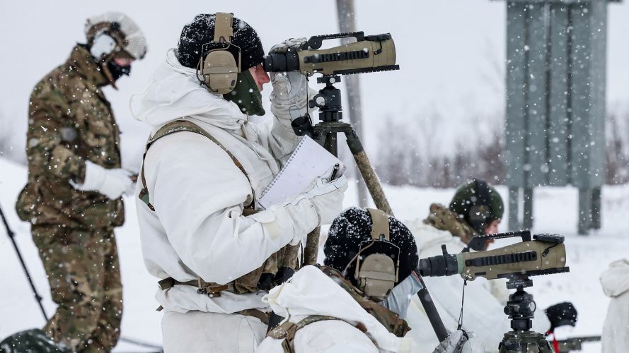 The firer is supported by a fellow Commando using a spotting scope, held steady on a tripod, to record the fall of shot and pass back any observations they may have