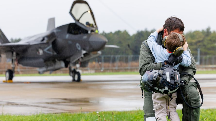 An F-35B pilot from 617 Squadron gives his son a hug in the rain after flying back to RAF Marham at the end of Operation Highmast An F-35B pilot from 617 Squadron gives his son a hug in the rain after flying back to RAF Marham at the end of Operation Highmast