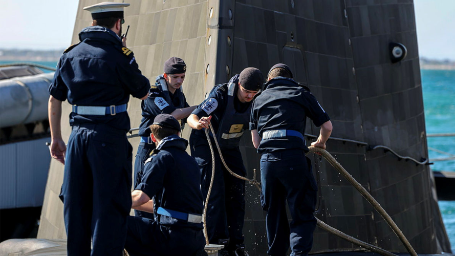 HMS Anson's crew closed up on the casing as the boat arrives into Australia