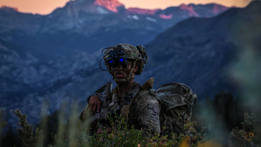 High up in the mountains of California, a Royal Marine surveys the land