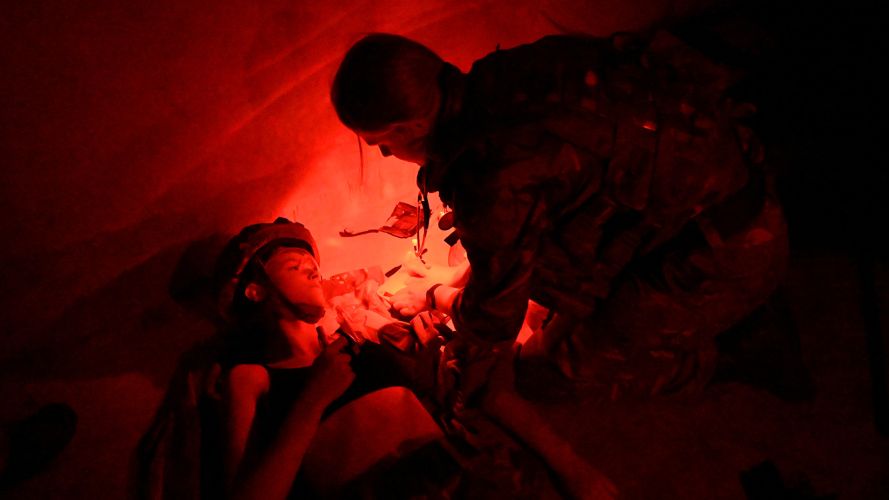 An Army medic practises her skills in darkness (Picture: USAF) An Army medic practises her skills in darkness