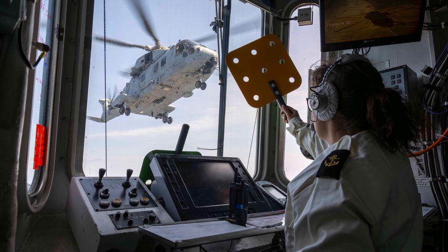 HMS Dragon's Flight Deck Officer gives a Merlin Mk4 permission to land as the helicopter delivers stores to the Type 45 air defence destroyer HMS Dragon's Flight Deck Officer gives a Merlin Mk4 permission to land as the helicopter delivers stores to the Type 45 air defence destroyer (Source: MOD)