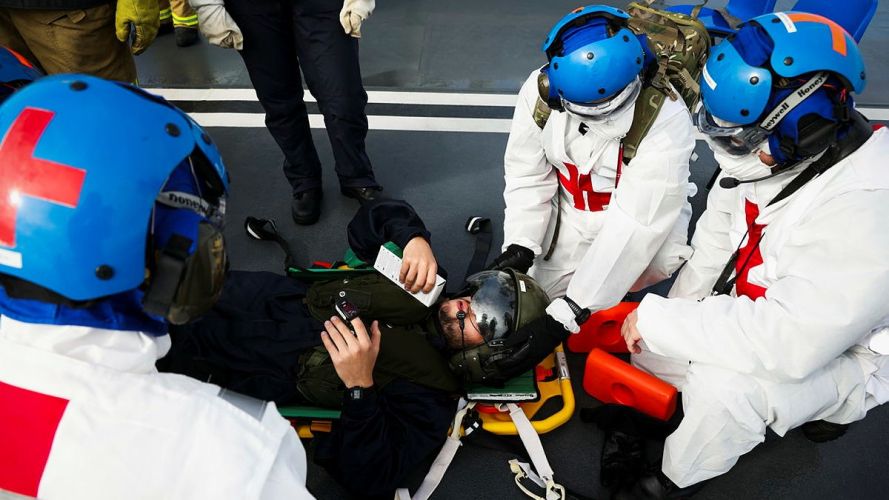 Medical teams treat a simulated casualty during the exercise on the flight deck of HMS Queen Elizabeth (Picture: MOD) HMS Queen Elizabeth crash-on-deck exercise