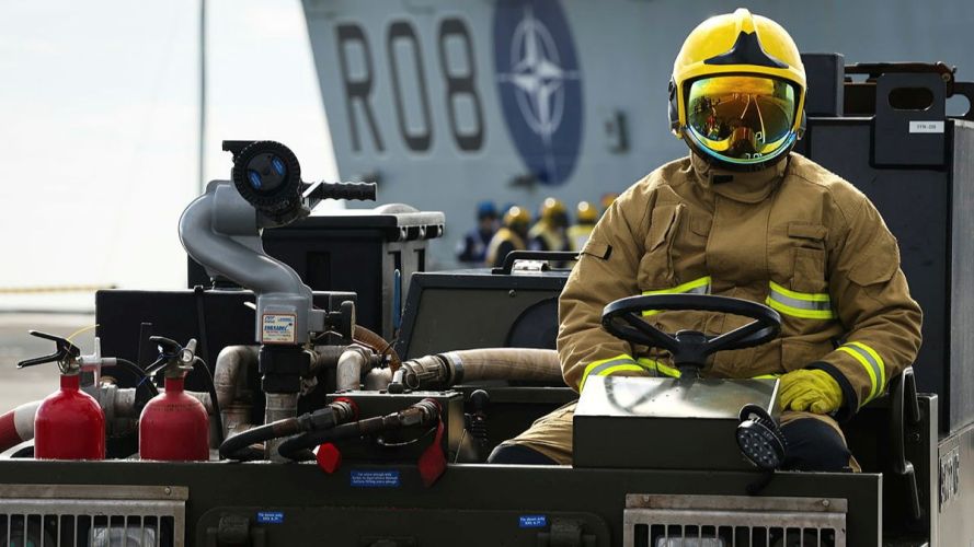 A Royal Navy firefighter mans a flight deck tractor during the crash-on-deck drill (Picture: MOD) HMS Queen Elizabeth crash-on-deck exercise