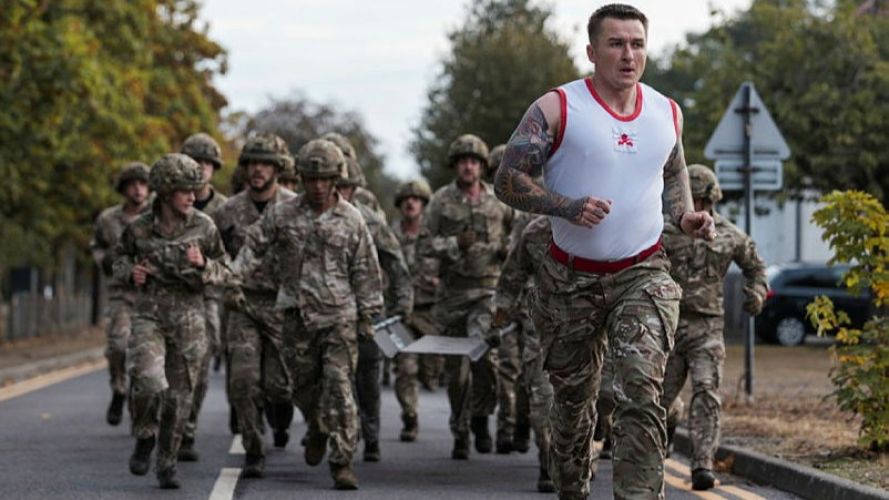 Members of 255 (Special Operations) Signal Squadron on a log run during Battle PT (Picture: MOD) 255 (Special Operations) Signal Squadron taking part in Battle PT during their Formation Day cred MOD