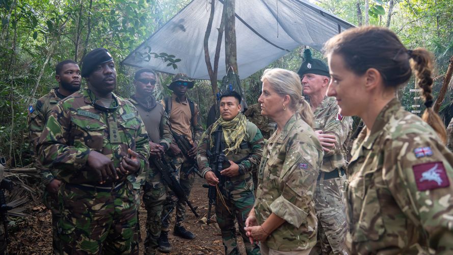 Duchess of Edinburgh listens to a member of personnel speaking 