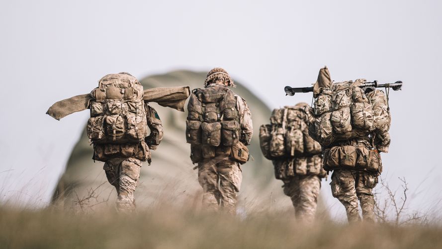 Paras from the mortar platoon make their way across the training area, bergens and weapons slung, regrouping after an airborne drop on Salisbury Plain
