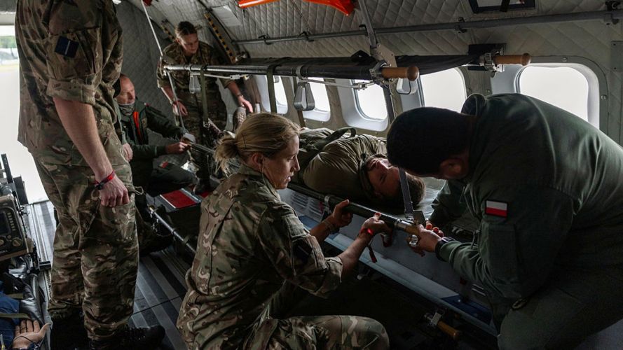 The RAF's Medical Team and Polish medics load a casualty onto an aircraft during a casevac (Picture: MOD)