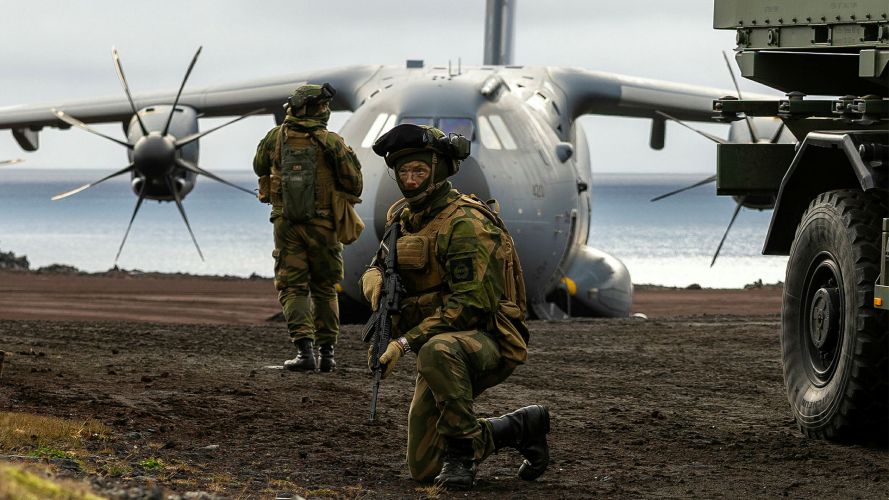A Norwegian reservist escorts a Strikemaster vehicle with an RAF A400M Atlas in the background as the two nations train together during Operation Atlantic City on the remote island of Jan Mayen A Norwegian reservist escorts a Strikemaster vehicle with an RAF A400M Atlas in the background as the two nations train together during Operation Atlantic City on the remote island of Jan Mayen