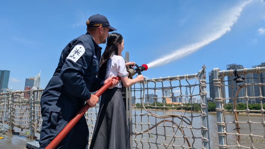 A Ho Chi Minh City schoolgirl is shown how to put out a fire pic MOD