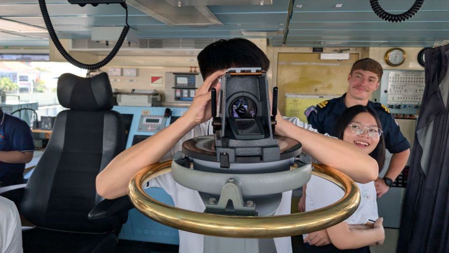 A visitor from the Christina Noble Children's Foundation takes a fix on HMS Spey's bridge (Picture: MOD)