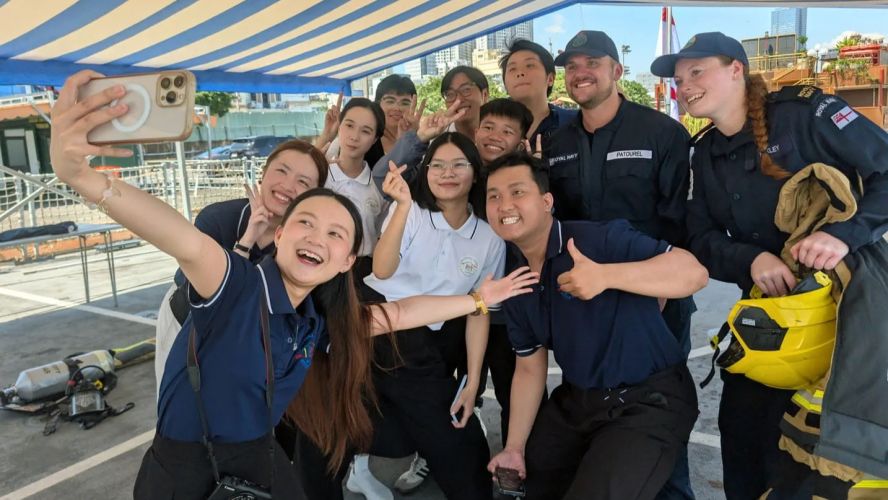 Youngsters from the Christina Noble Childrens Foundation pose with crew of HMS Spey on the flight deck in Ho Chi Minh City pic MOD