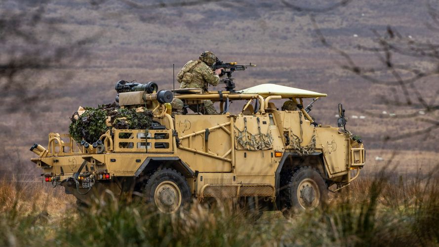 A soldier from 4 Ranger opens fire with the 7.62mm general purpose machine gun mounted to the top of a Jackal 2, providing support for two simultaneous assaults on a target building
