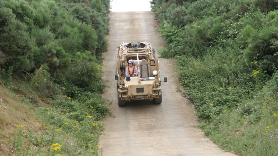 A Jackal Patrol Vehicle experimental hybrid reverses up a steep hill using battery power only at Millbrook Proving Ground.