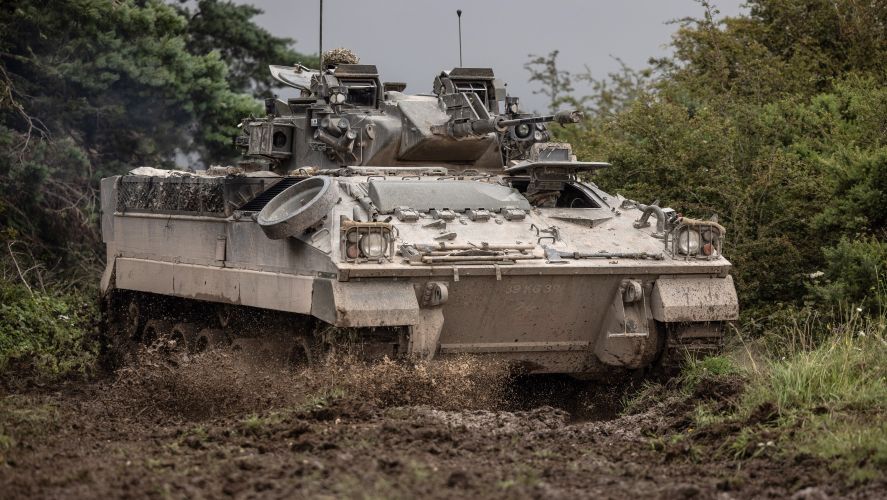 A Warrior vehicle manoeuvring through muddy terrain during Exercise IRON CYCLONE 24072023 CREDIT MOD.jpg