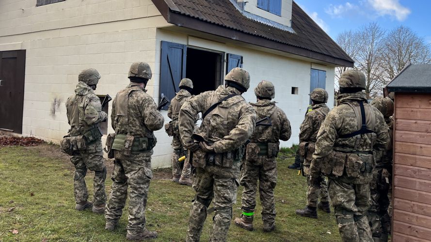 A group of Ukrainian recruits in a UK village designed to replicate a Ukrainian settlement.